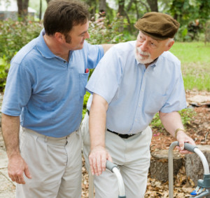 Adult son out for a walk with his father, who has alzheimers disease.